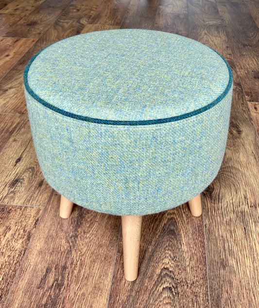 Light Green Harris Tweed Footstool with Dark Green Piping and Varnished Wooden Legs.