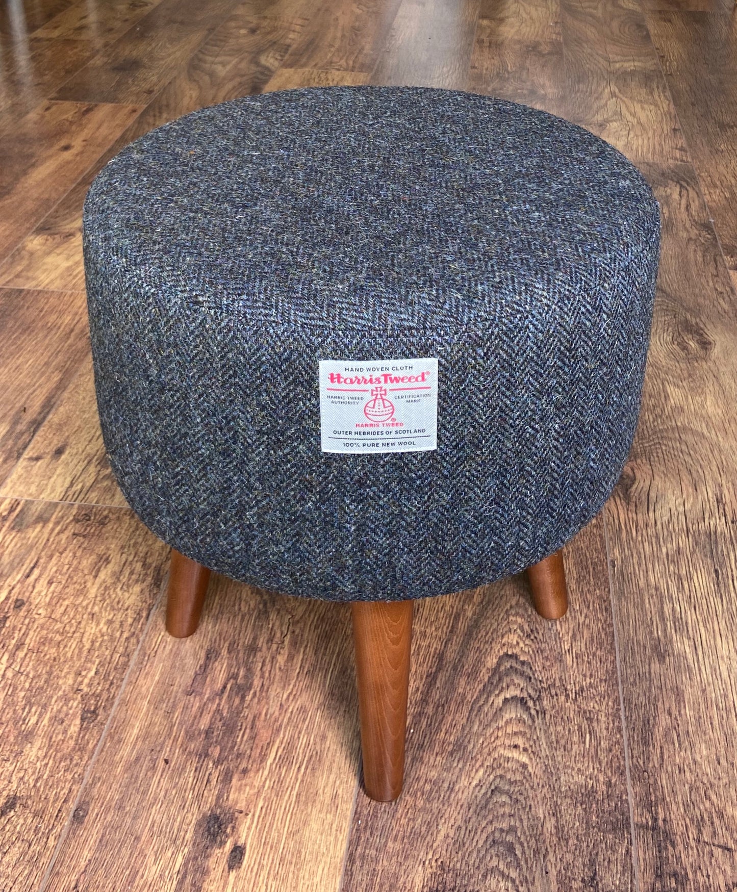 Charcoal Harris Tweed Upholstered Footstool with Dark Varnished Wooden Legs.