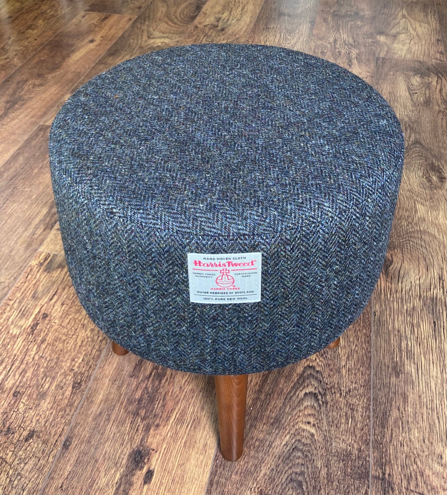 Charcoal Harris Tweed Upholstered Footstool with Dark Varnished Wooden Legs.