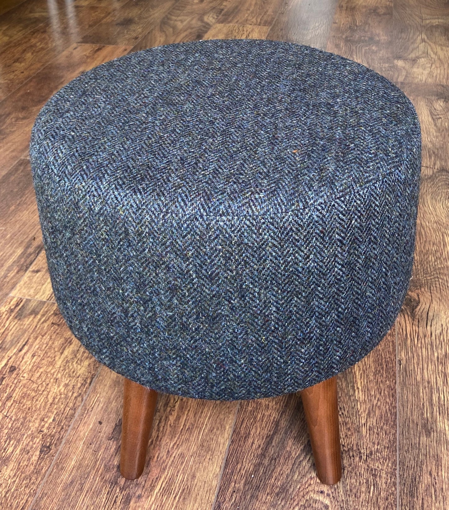 Charcoal Harris Tweed Upholstered Footstool with Dark Varnished Wooden Legs.