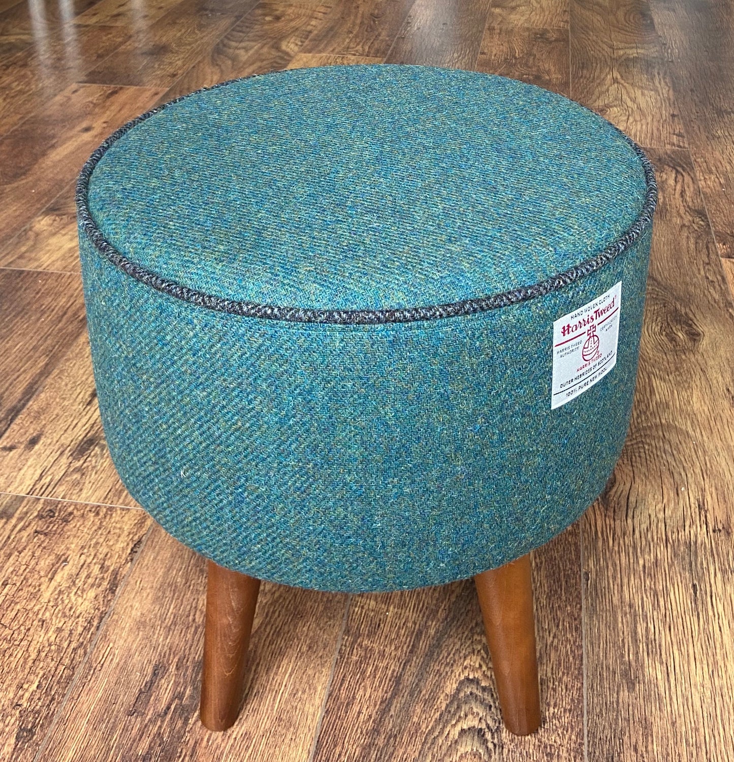 Green Harris Tweed Footstool with Charcoal Piping and Dark Varnished Wooden Legs.