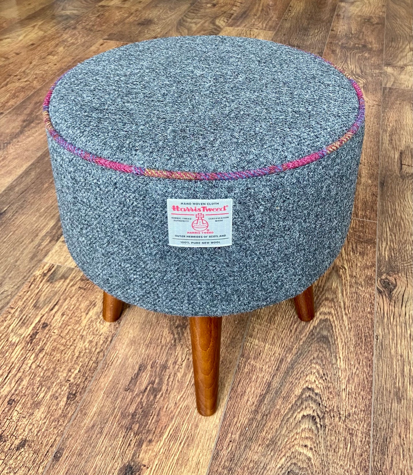 Charcoal Harris Tweed Upholstered Footstool with Dark Varnished Wooden Legs.