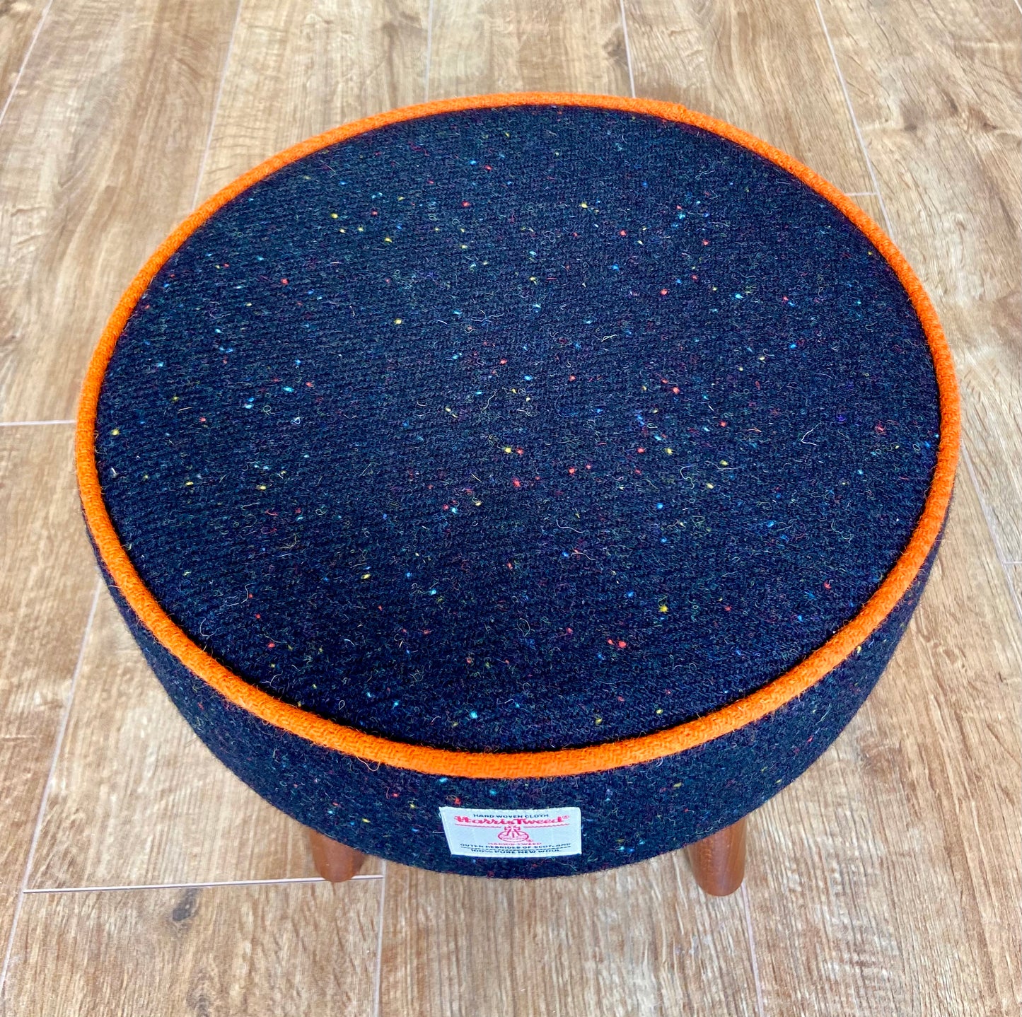 Black Speckled Harris Tweed Footstool with Orange Piping and Dark Varnished Wooden Legs