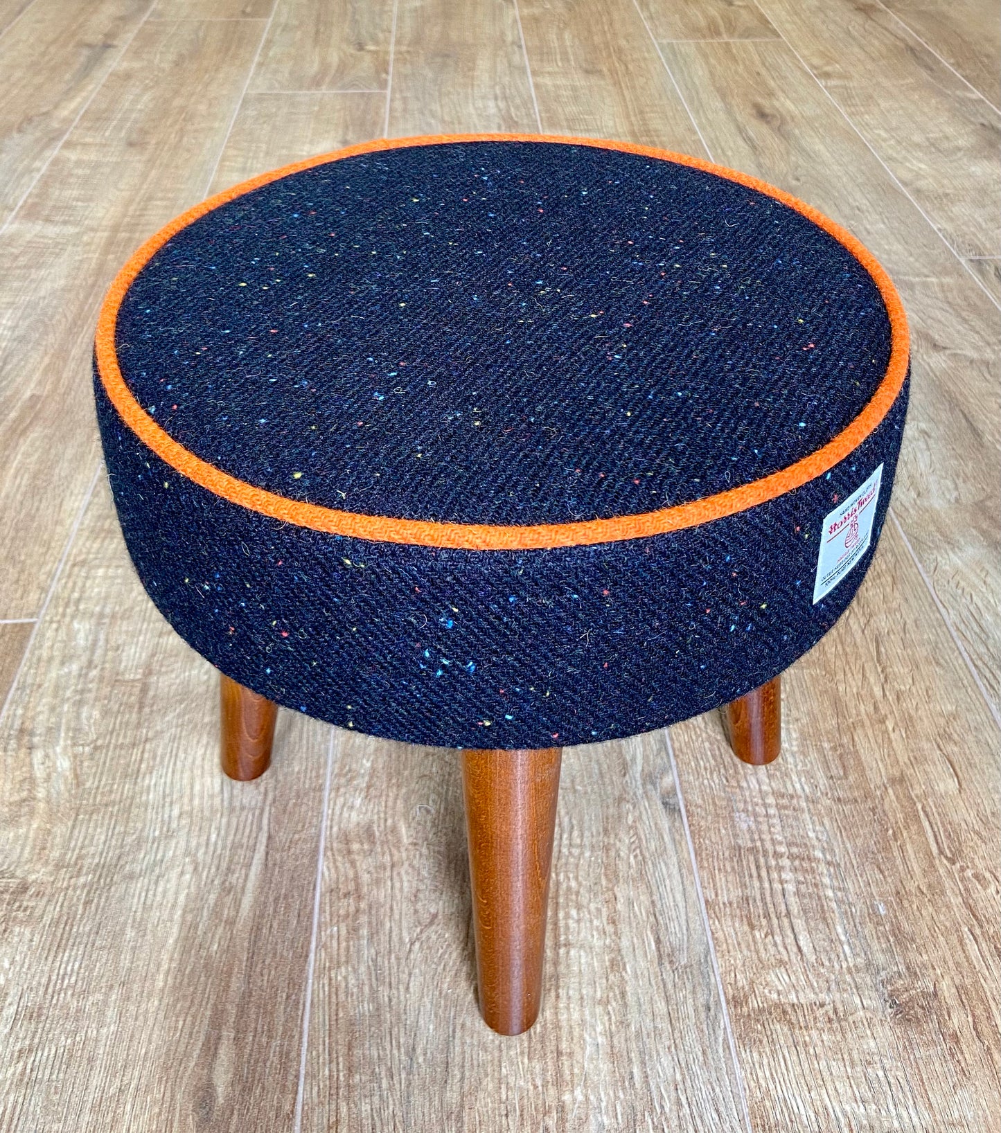 Black Speckled Harris Tweed Footstool with Orange Piping and Dark Varnished Wooden Legs