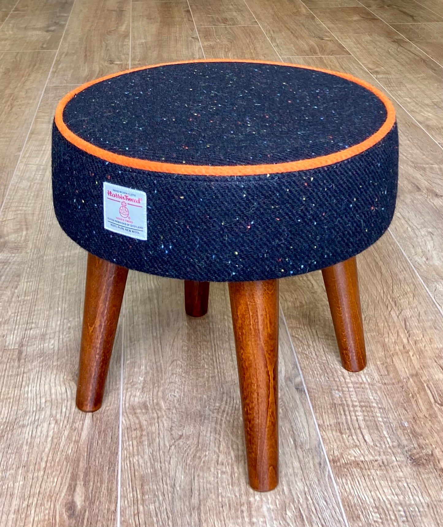 Black Speckled Harris Tweed Footstool with Orange Piping and Dark Varnished Wooden Legs