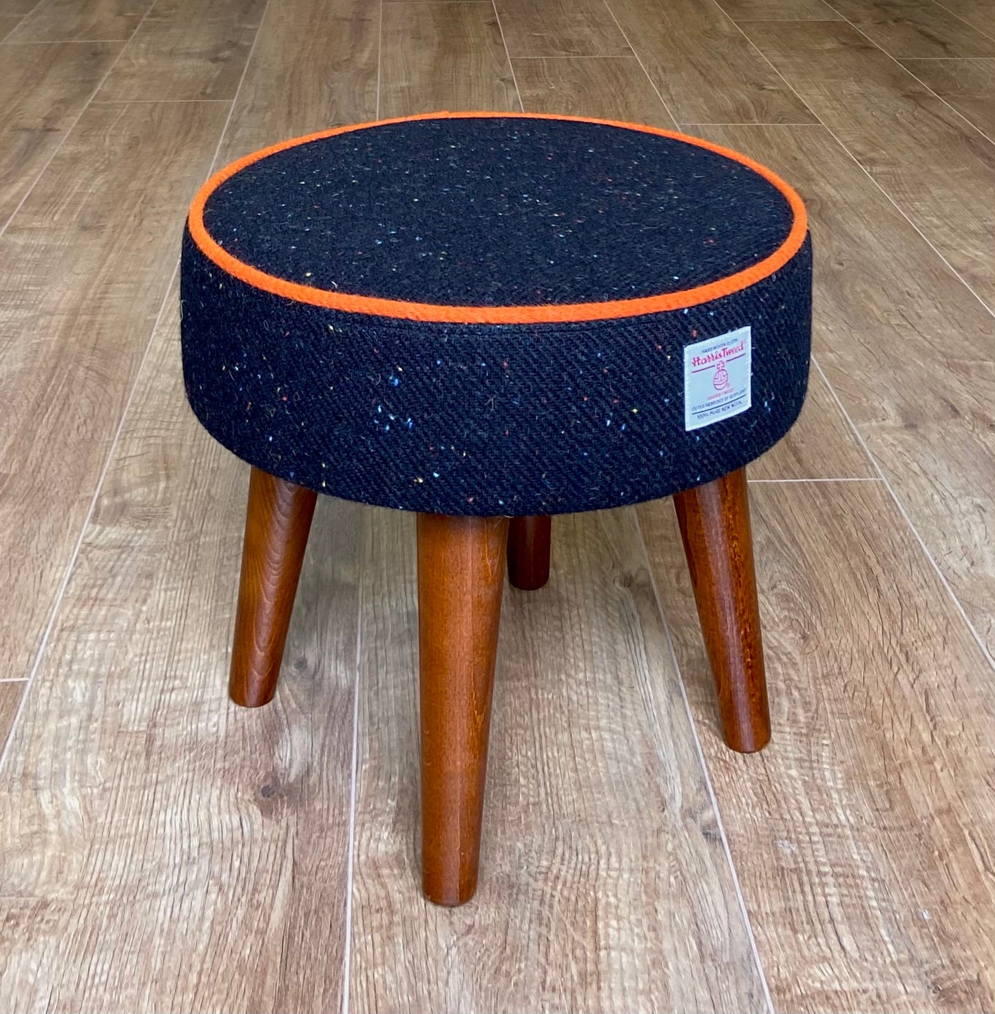 Black Speckled Harris Tweed Footstool with Orange Piping and Dark Varnished Wooden Legs